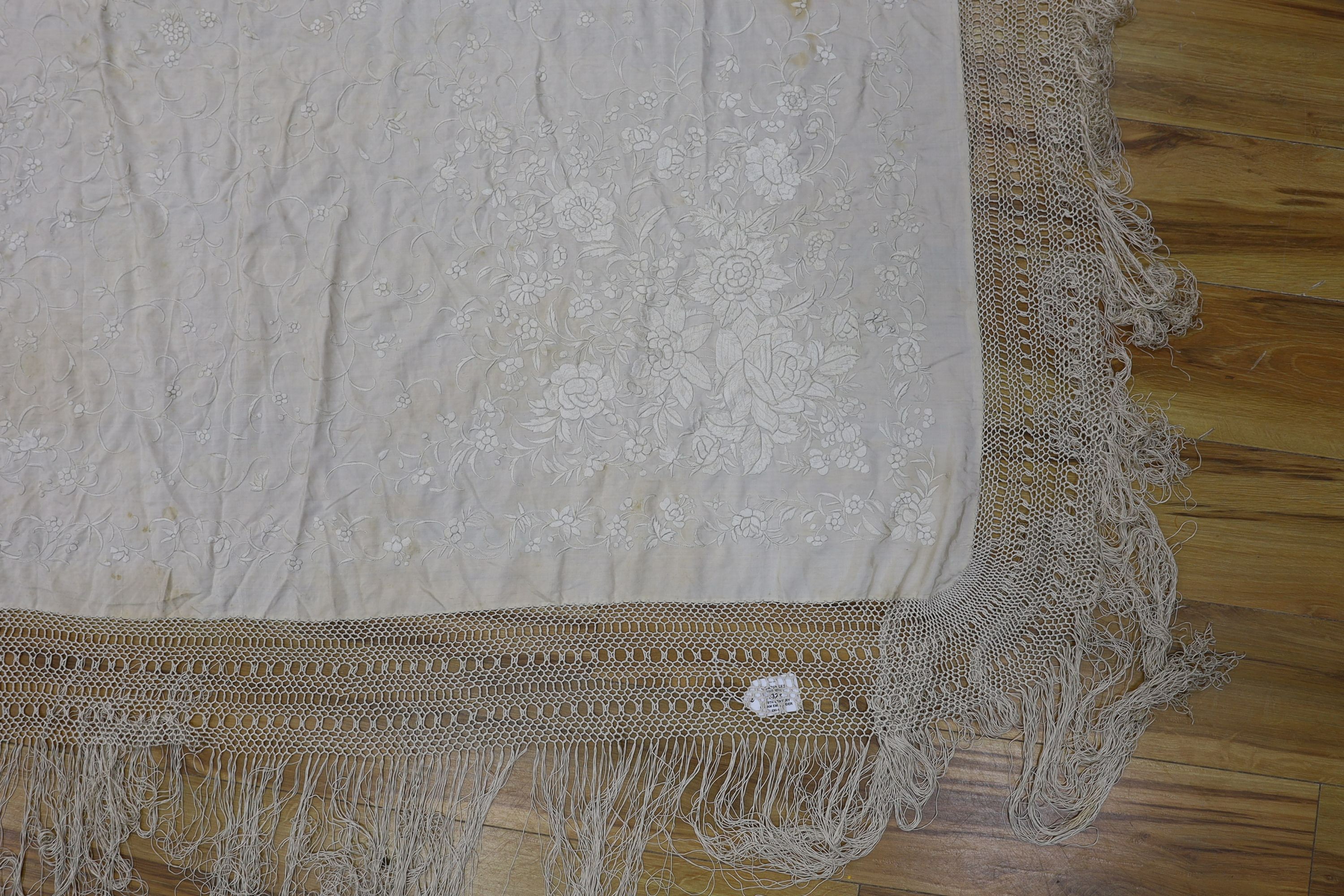 A 19th century cream embroidery on cream silk shawl together with a smaller later shawl